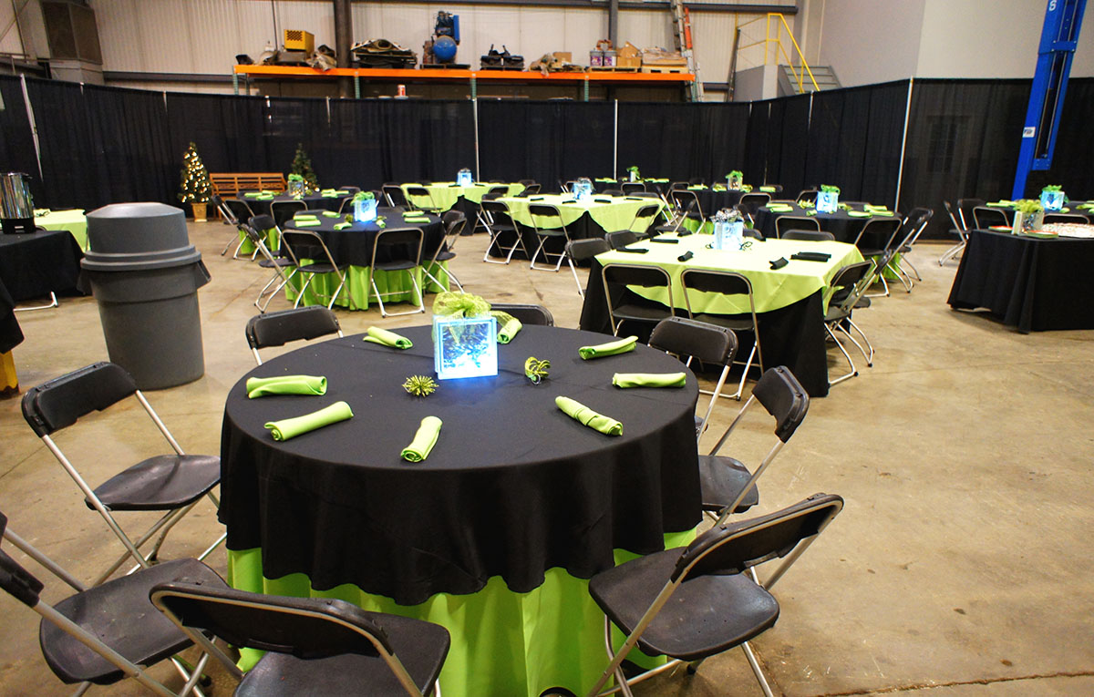 120" Round Lime Solid Tablecover With 90" Round Black Solid Topper On 60" Round Table And 120x120 Black Solid Tablecovers With 90" Round Lime Solid Toppers On 60x60 Wood Topped Tables
